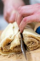 Cutting into cinnamon rolls.